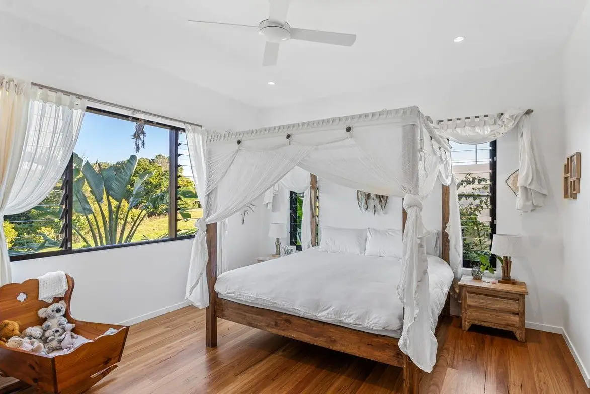 Bedroom with a canopy bed and garden outlook
