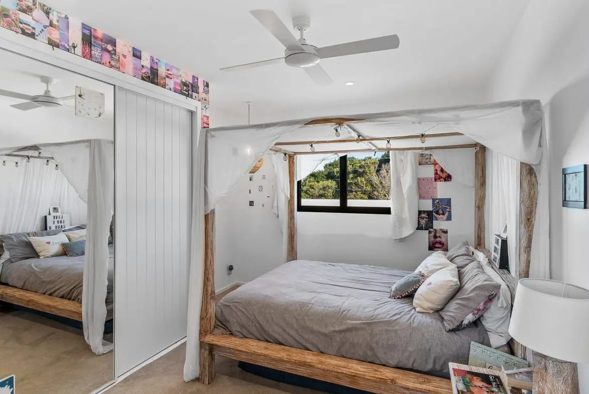 Second bedroom with a timber bed frame