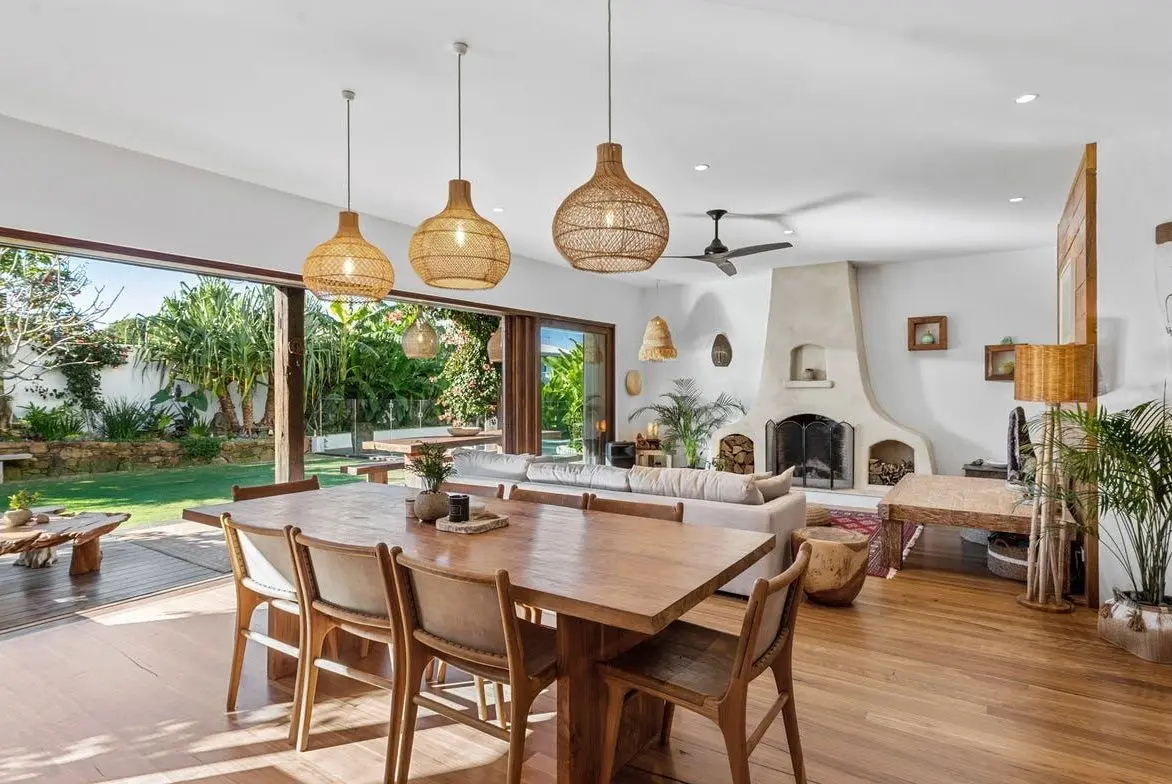 Dining area under rattan pendants, opening to the garden