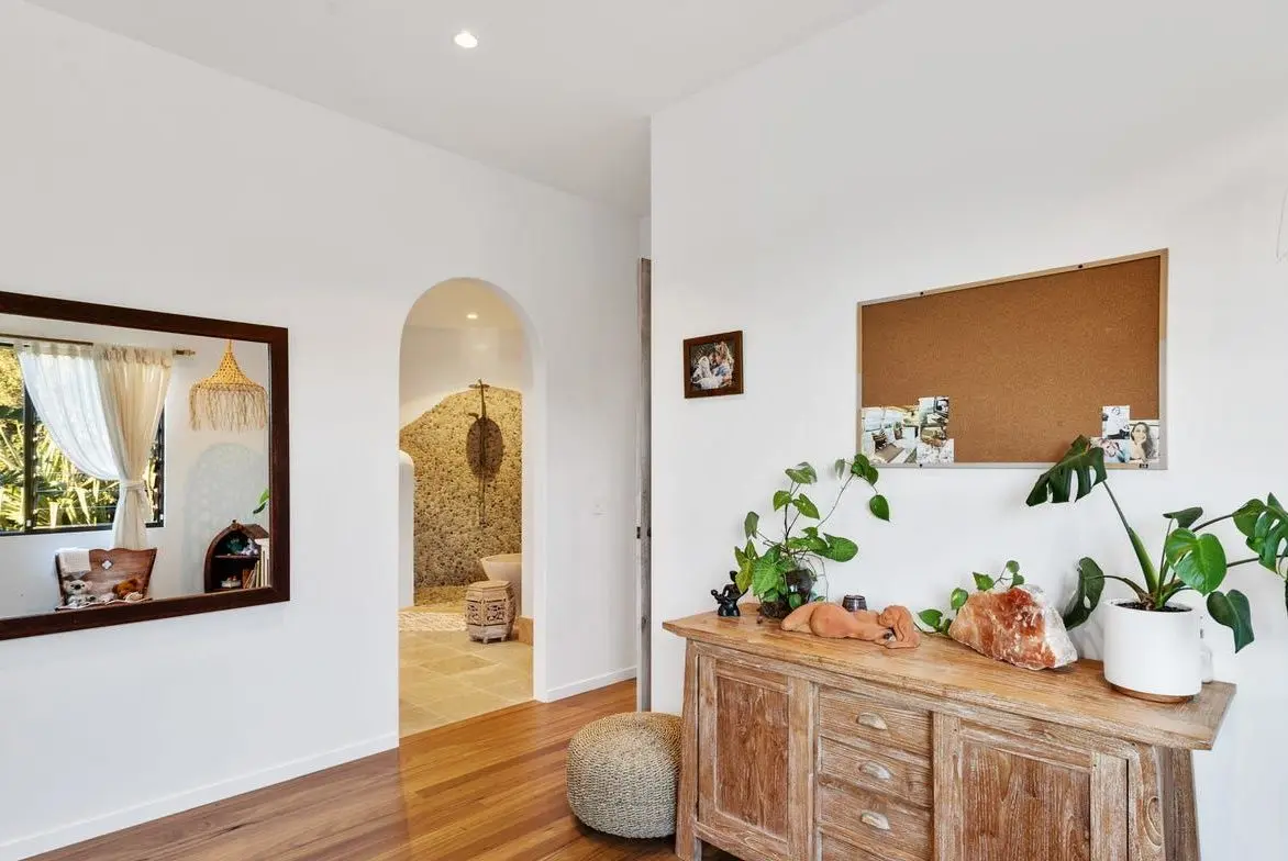 Hallway with an arched doorway and timber sideboard