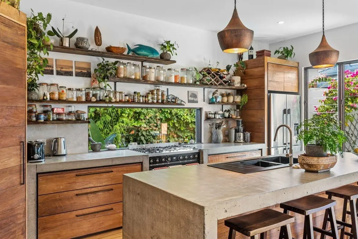 Kitchen with timber shelving, concrete benchtops and a garden window