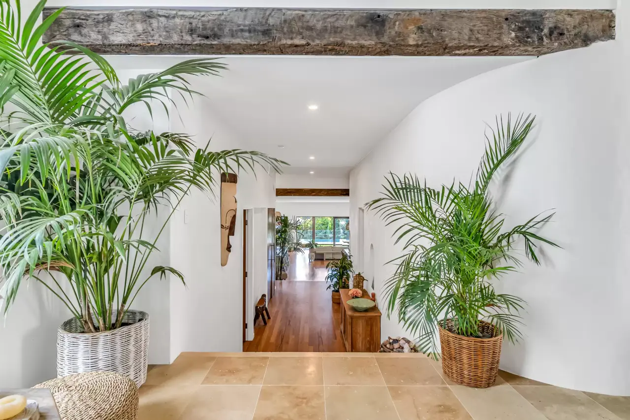Entry hall with stone floor and palms
