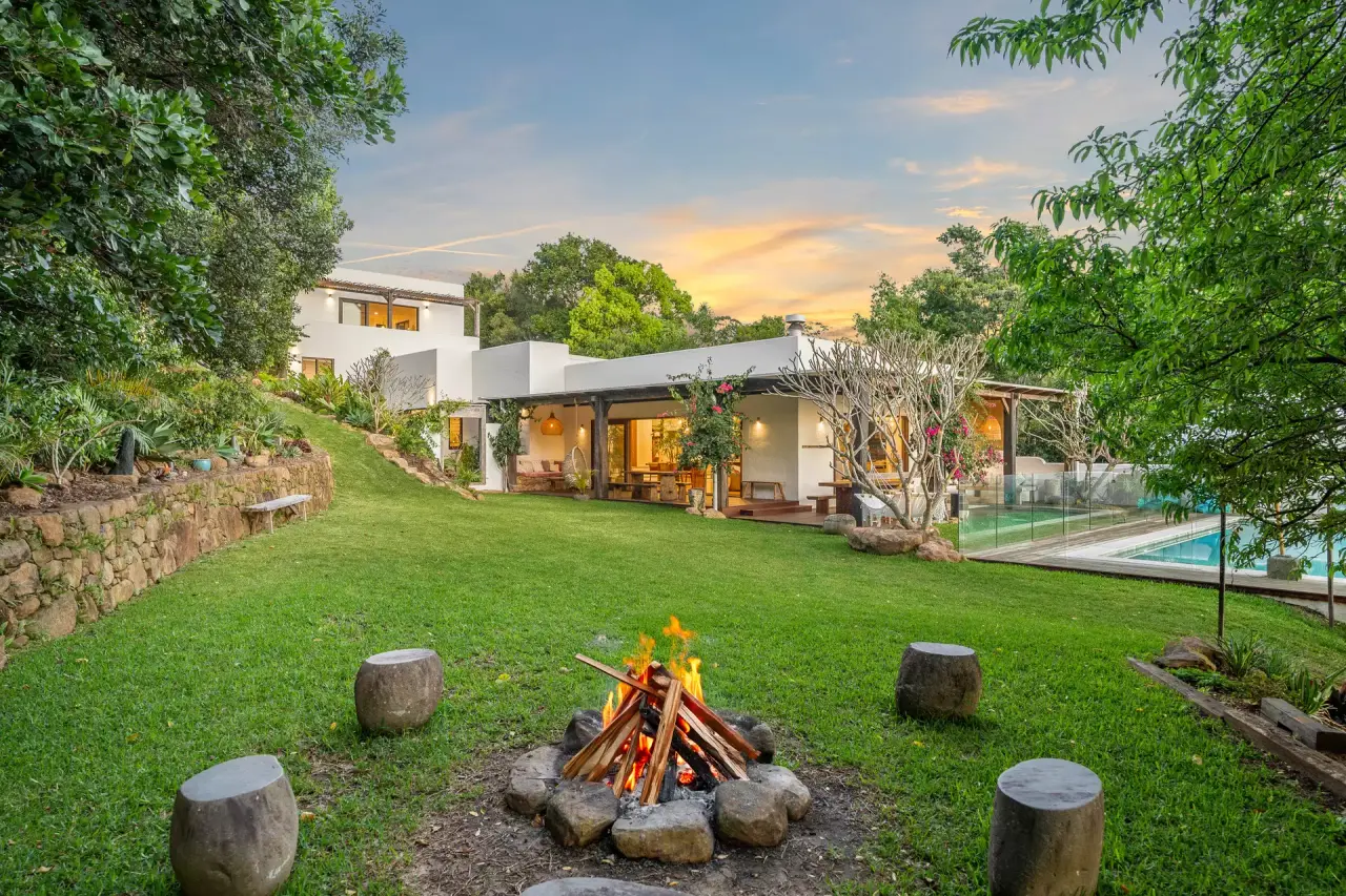 Fire pit on the lawn below the house