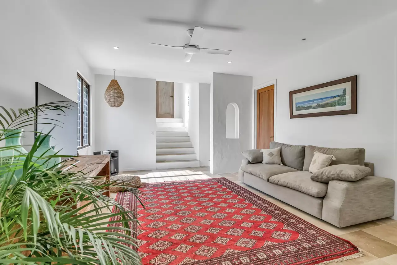 Living room with an arched niche and stair