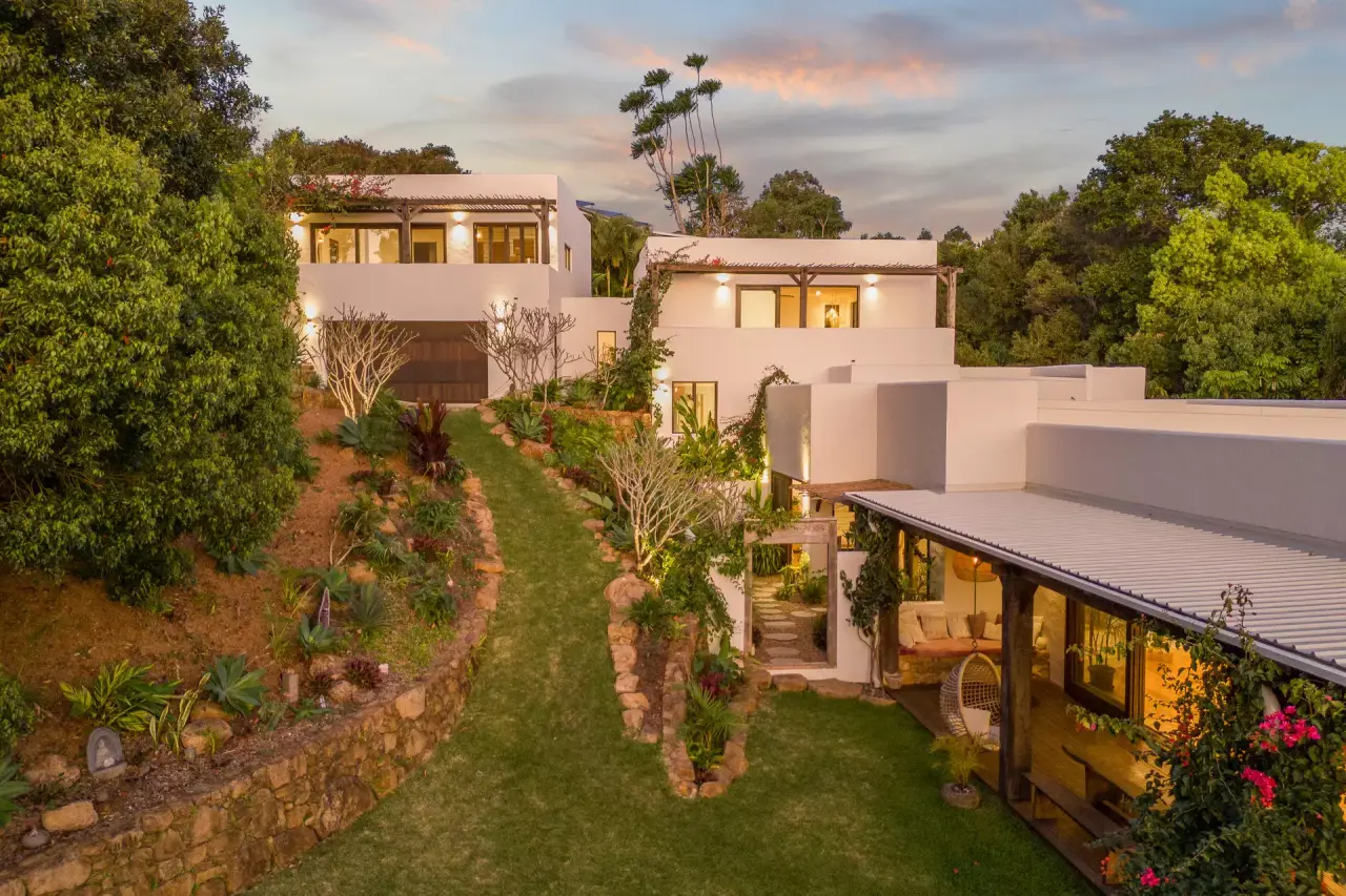 White rendered pavilions above a terraced garden